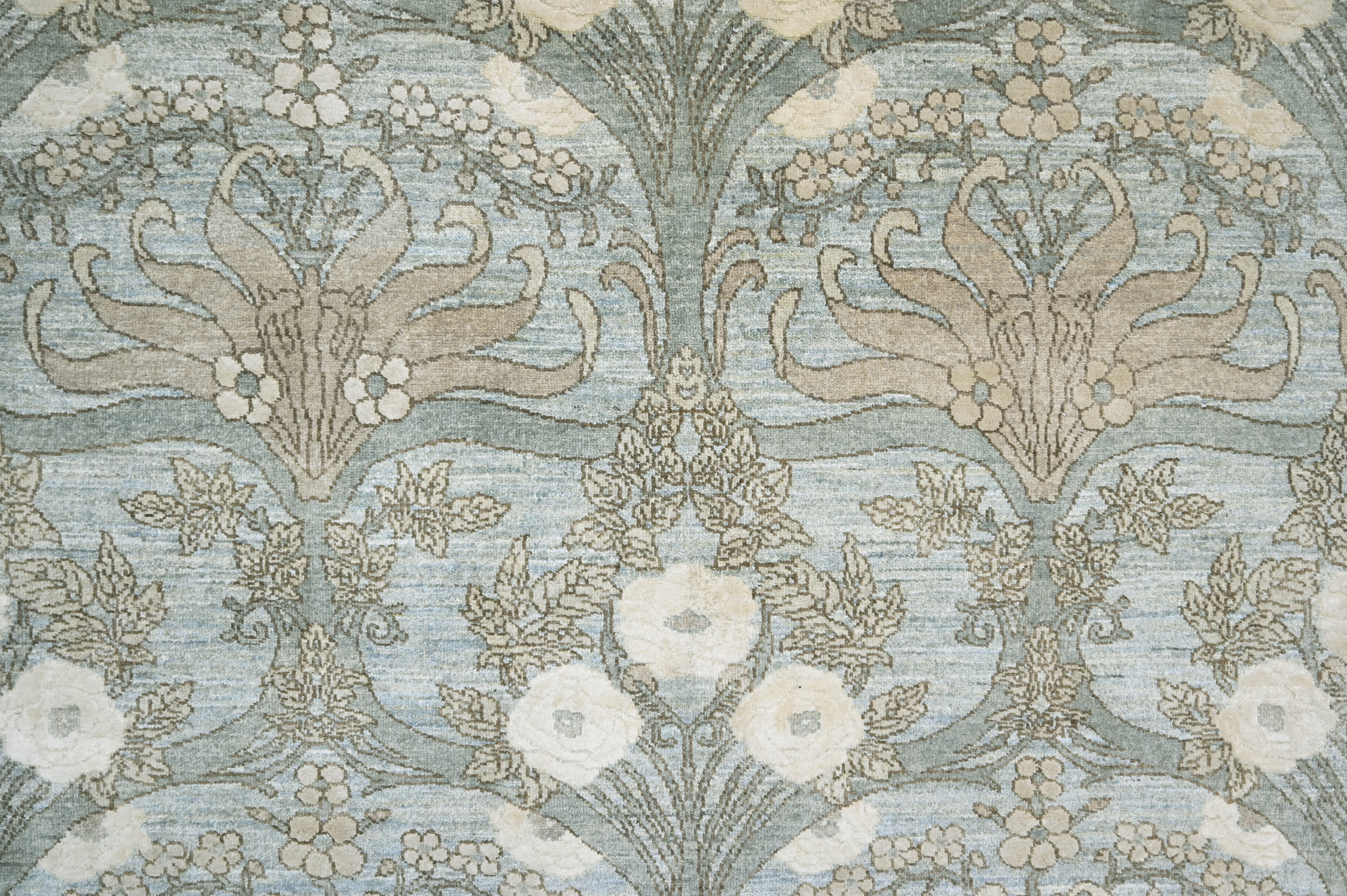 Decorative wallpaper with floral and leaf patterns in beige and blue.