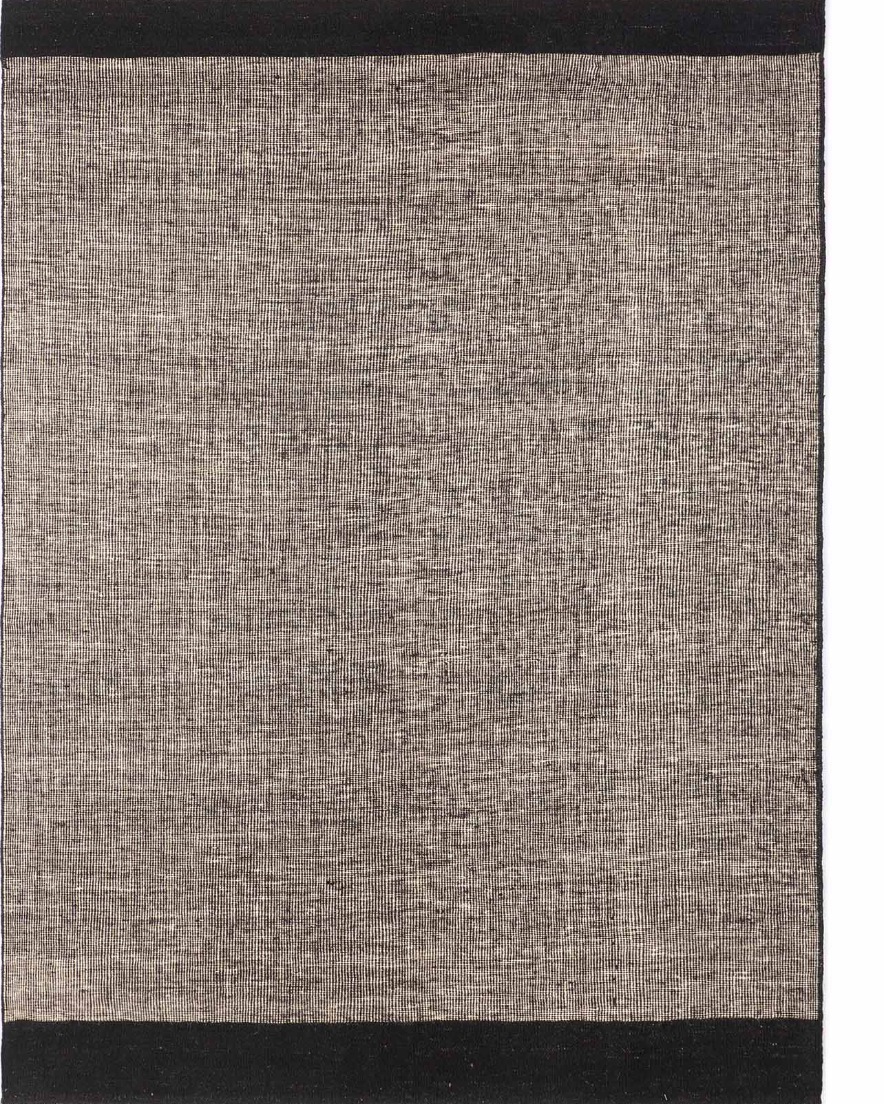 A rectangular kilim rug with a solid pattern, primarily in a gray shade, with a black border at the top and bottom.