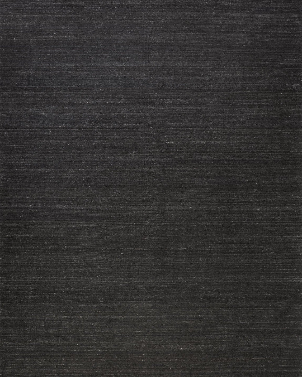 A flatweave kilim rug in dark color, showing the texture and weave of the wool.