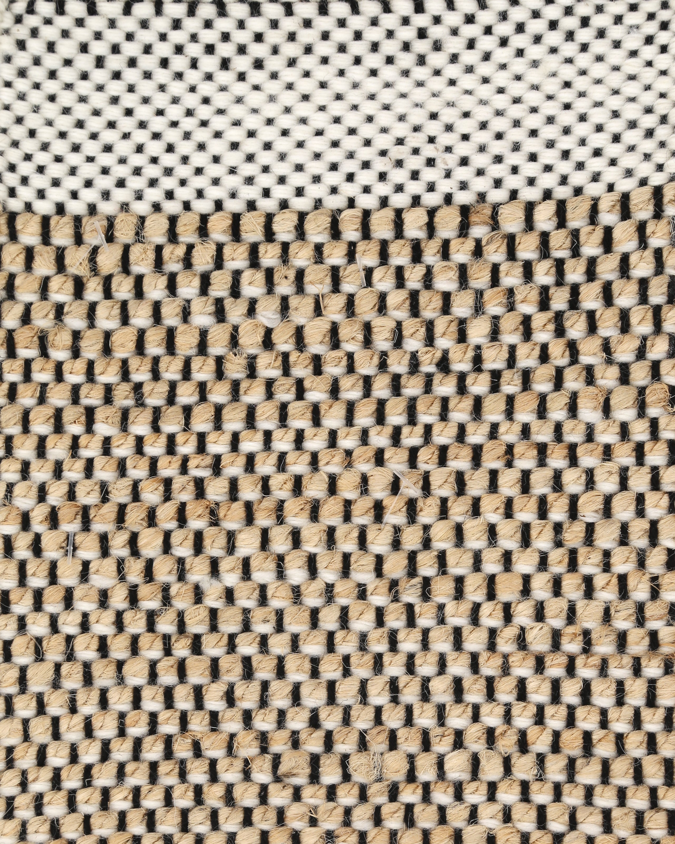 A rectangular area rug with a geometric pattern featuring beige, white, and brown colors. Bellagio ivory