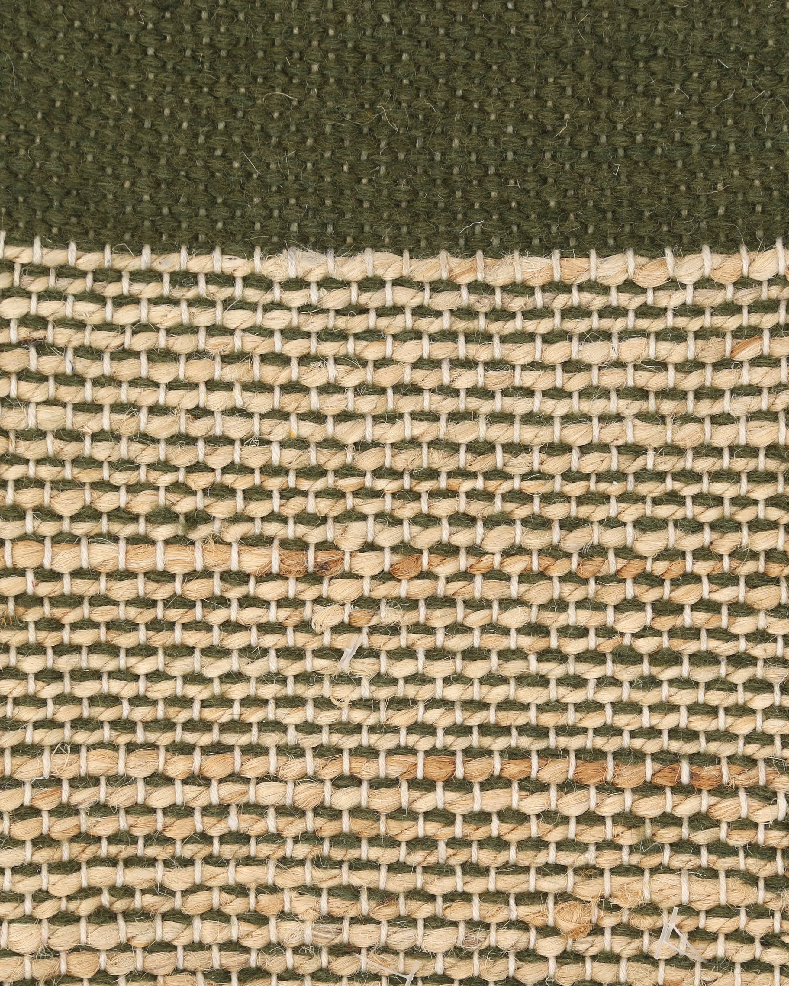 A rectangular jute moss green carpet sample with a textured pattern.