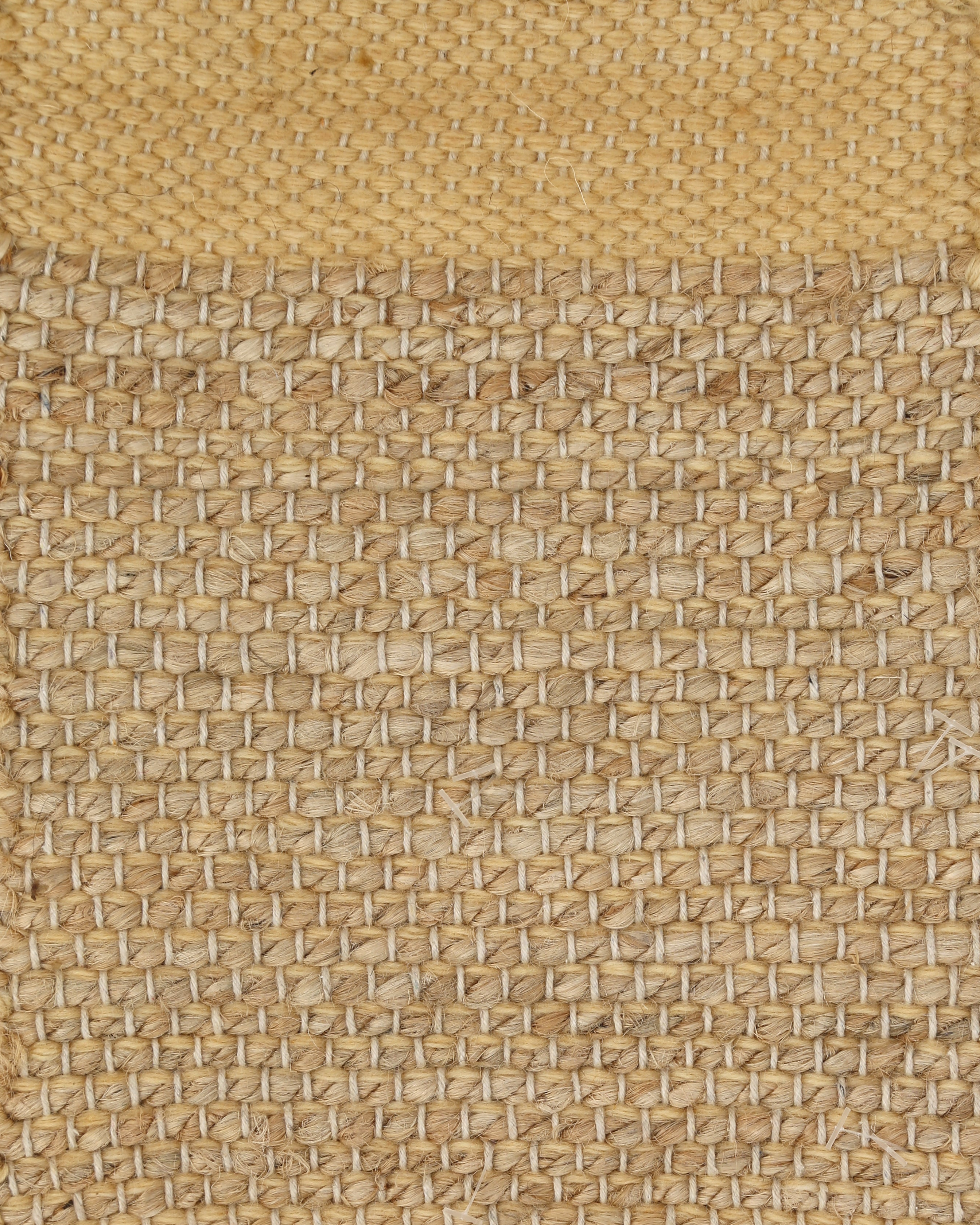 A rectangular jute rug with beige color featuring a geometric pattern.