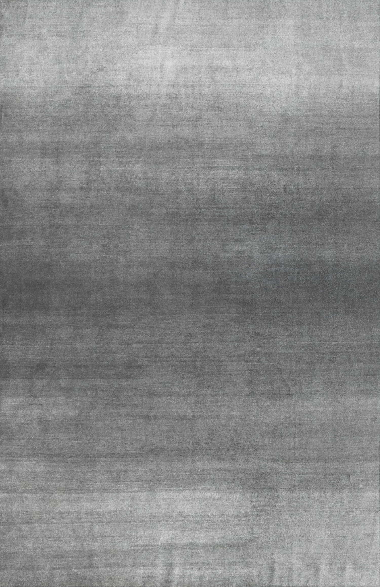 A sleek modern gradient rug with a subtle gradient effect in a minimalist design, predominantly in a grey tone.