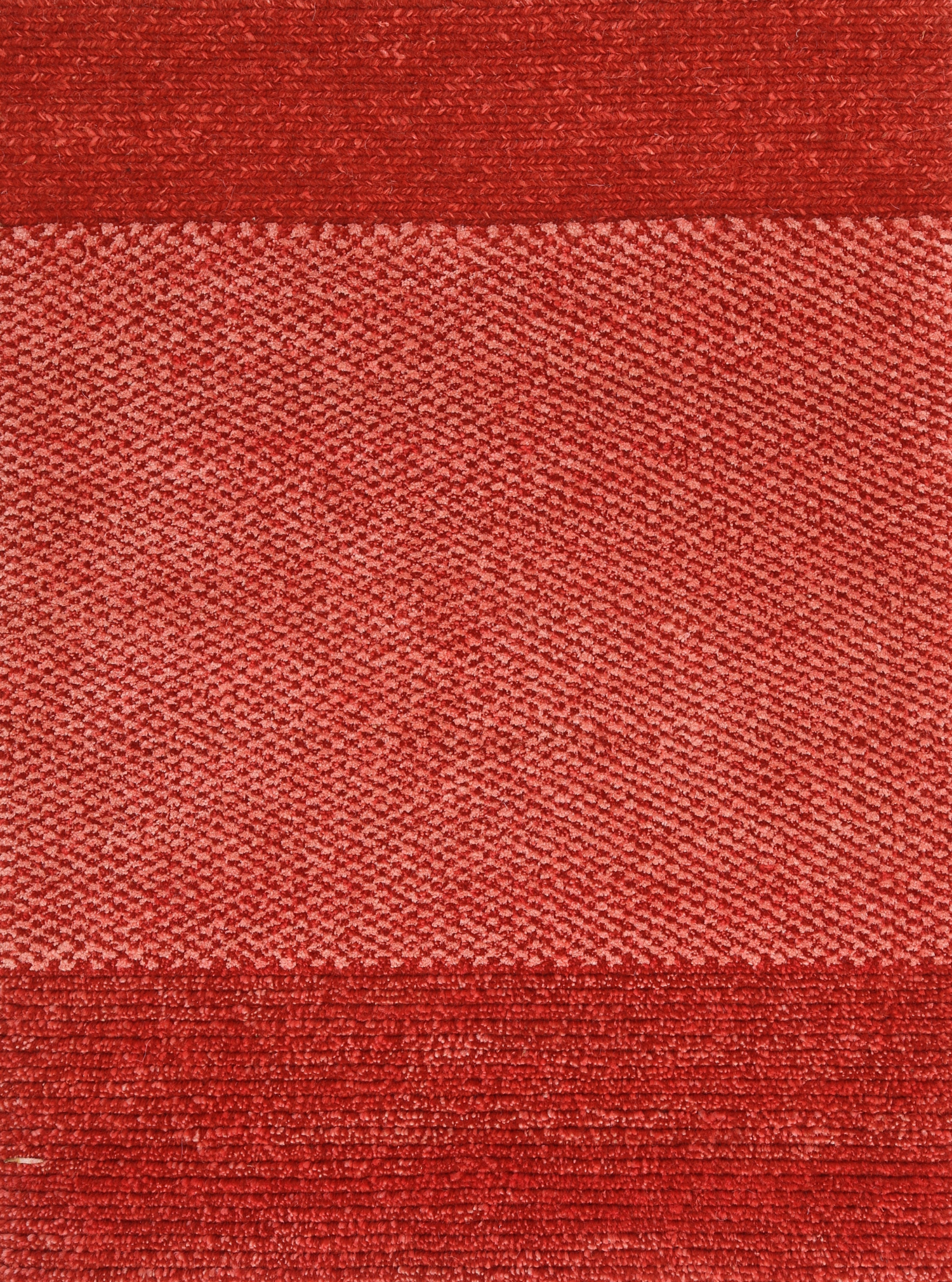 A red carpet sample with a textured pattern chromatic red architecturals damboord rug tapijt