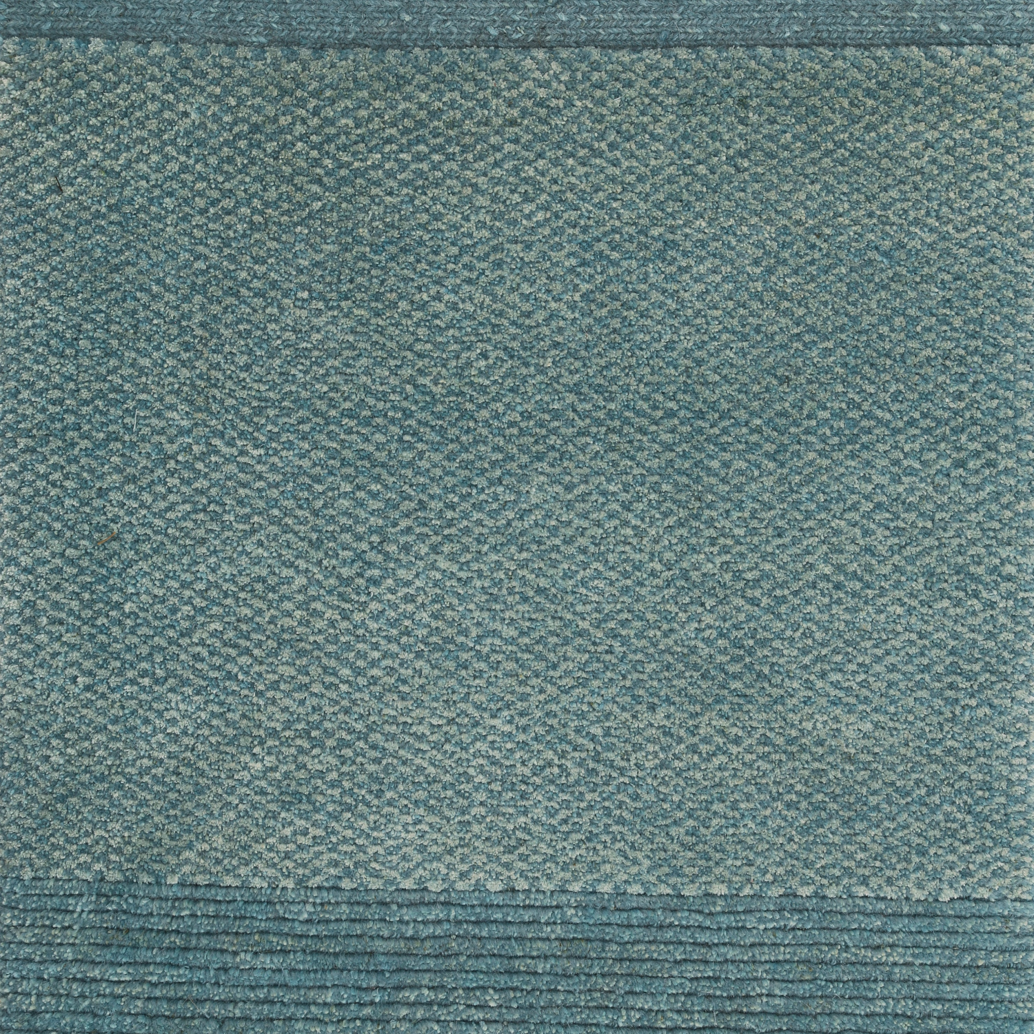 A small rectangular sample of a blue carpet with a textured design. chromatic architecturals damboord tapijt