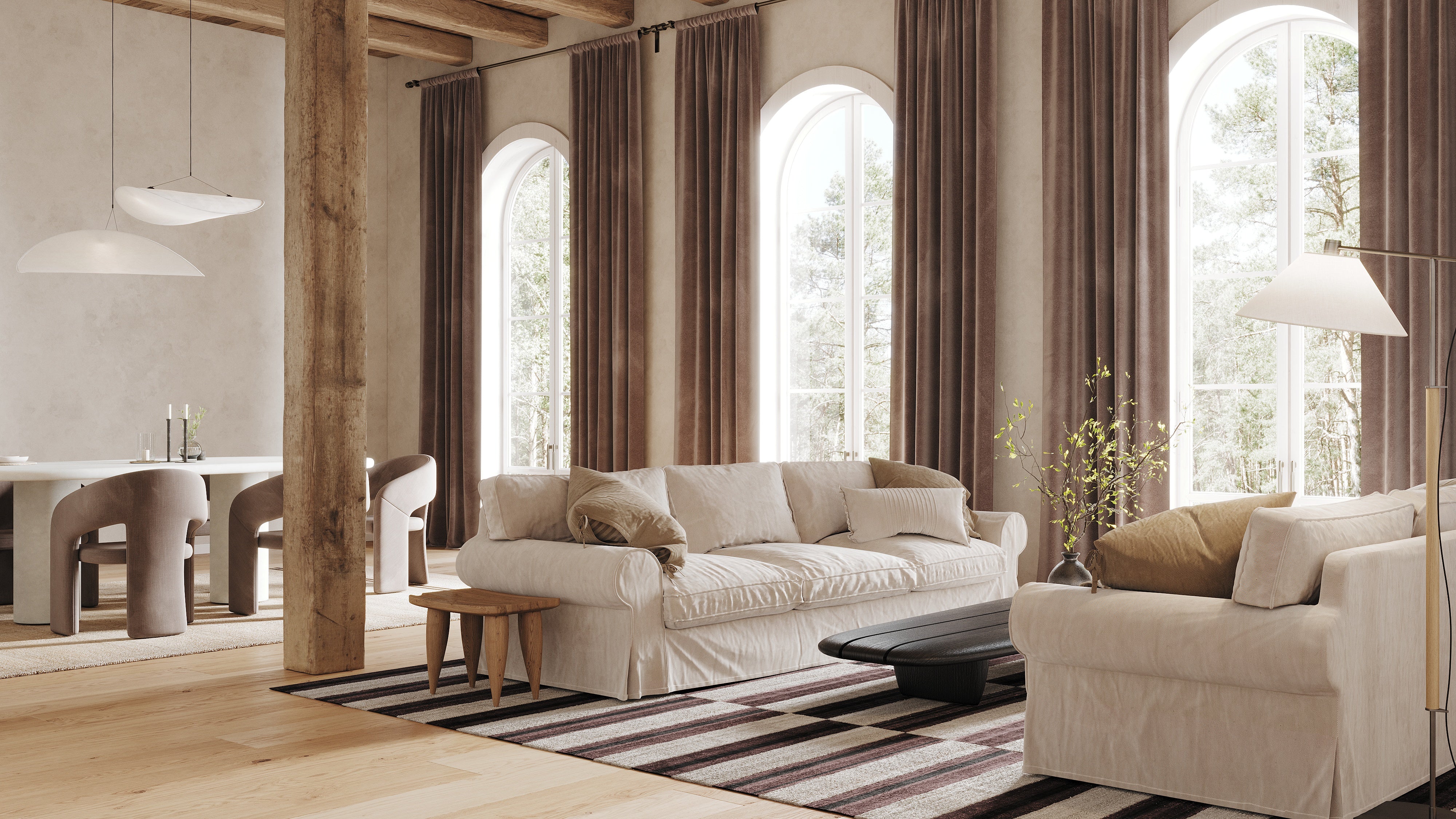 Modern living room with beige sofa, striped rug, and large windows.