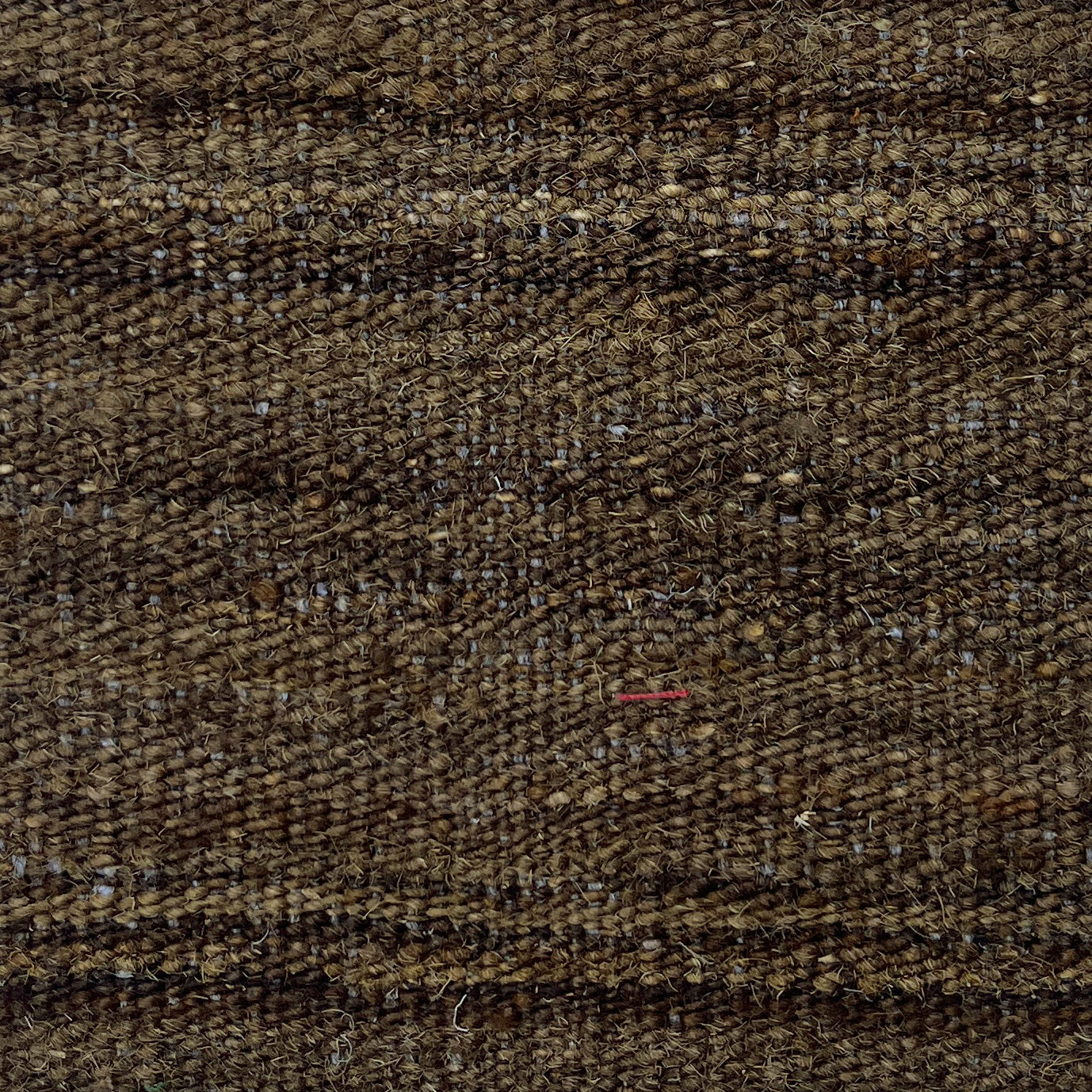 Close-up of brown textured fabric with subtle pattern