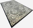 Decorative art-nouveau rug with black and white abstract pattern on a plain background