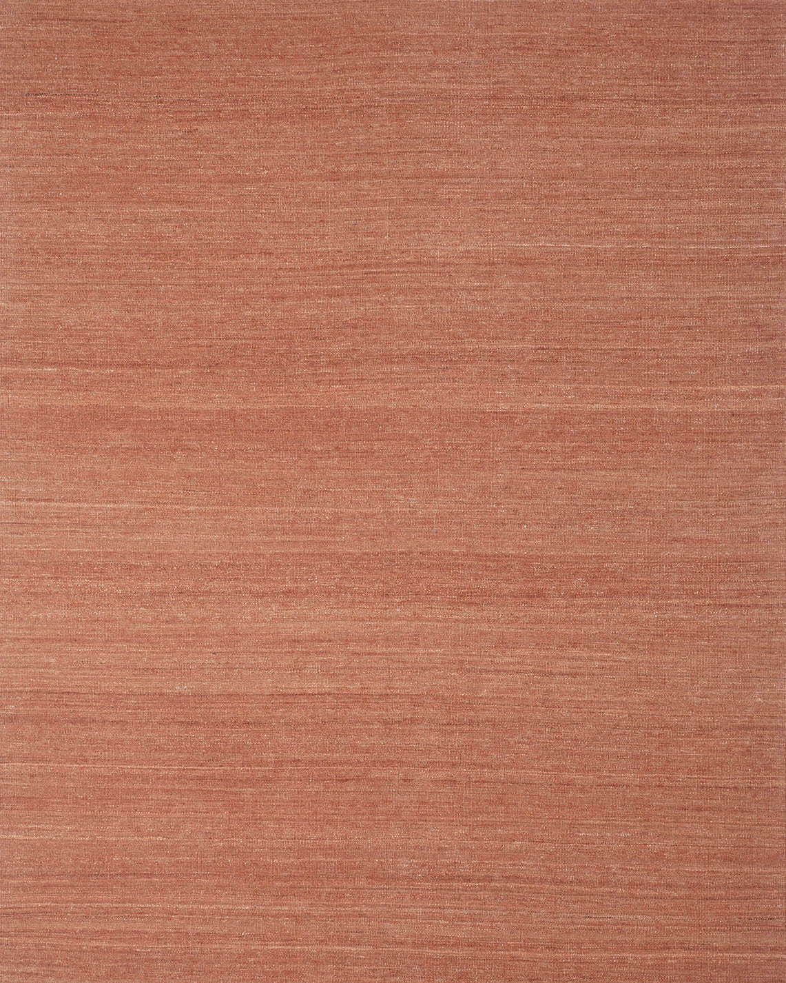 A rectangular, handwoven kilim rug in a solid terracotta color.