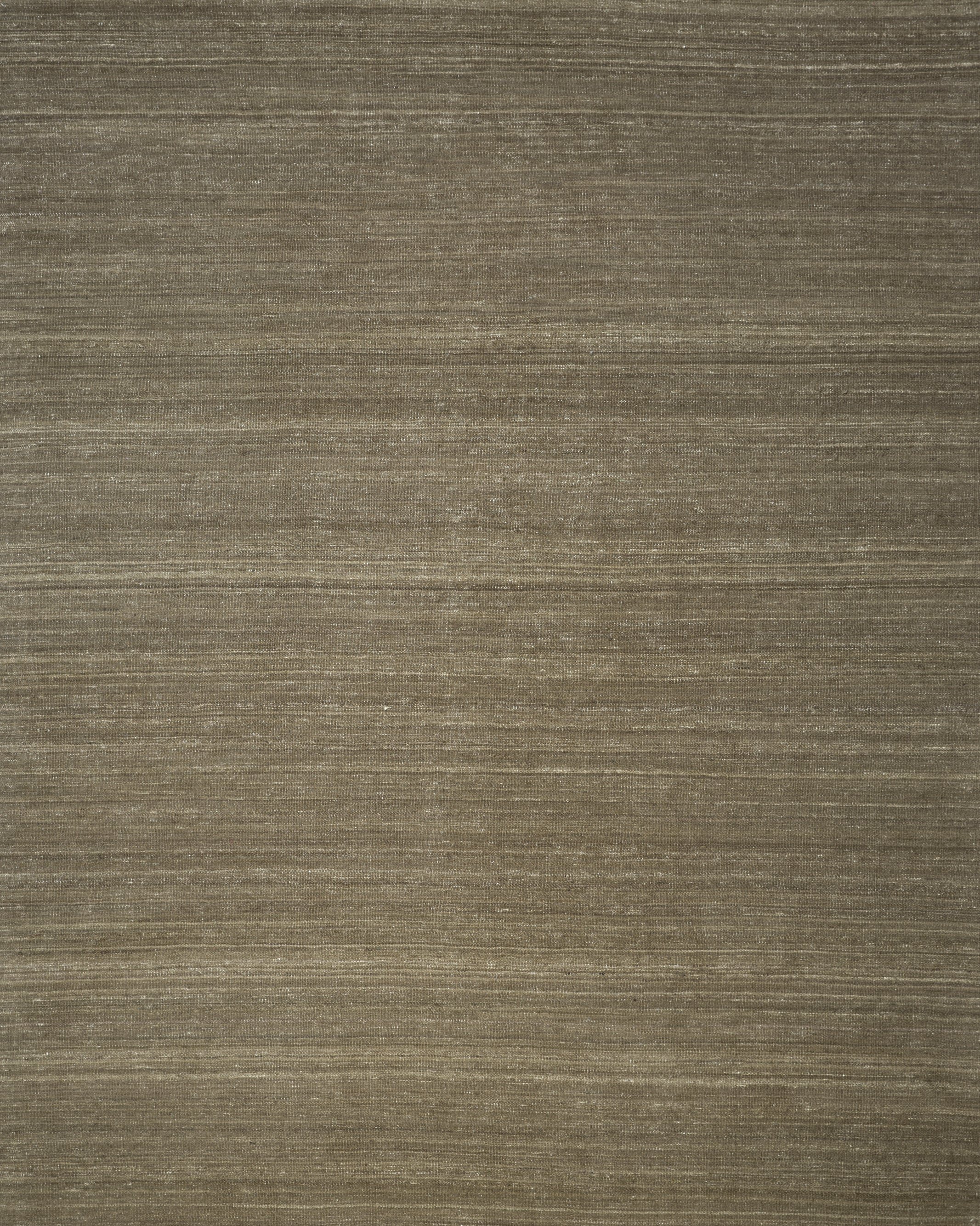 A flatweave kilim rug in a neutral color, displaying the texture and weave of the fibers.