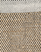 A rectangular area rug with a geometric pattern featuring beige, white, and brown colors. Bellagio ivory