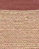 A rectangular Bellagio jute rug with a Vieux Rose (old pink) color border and a plain weave center.