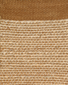 A rectangular jute rug with a textured design in beige and brown colors.