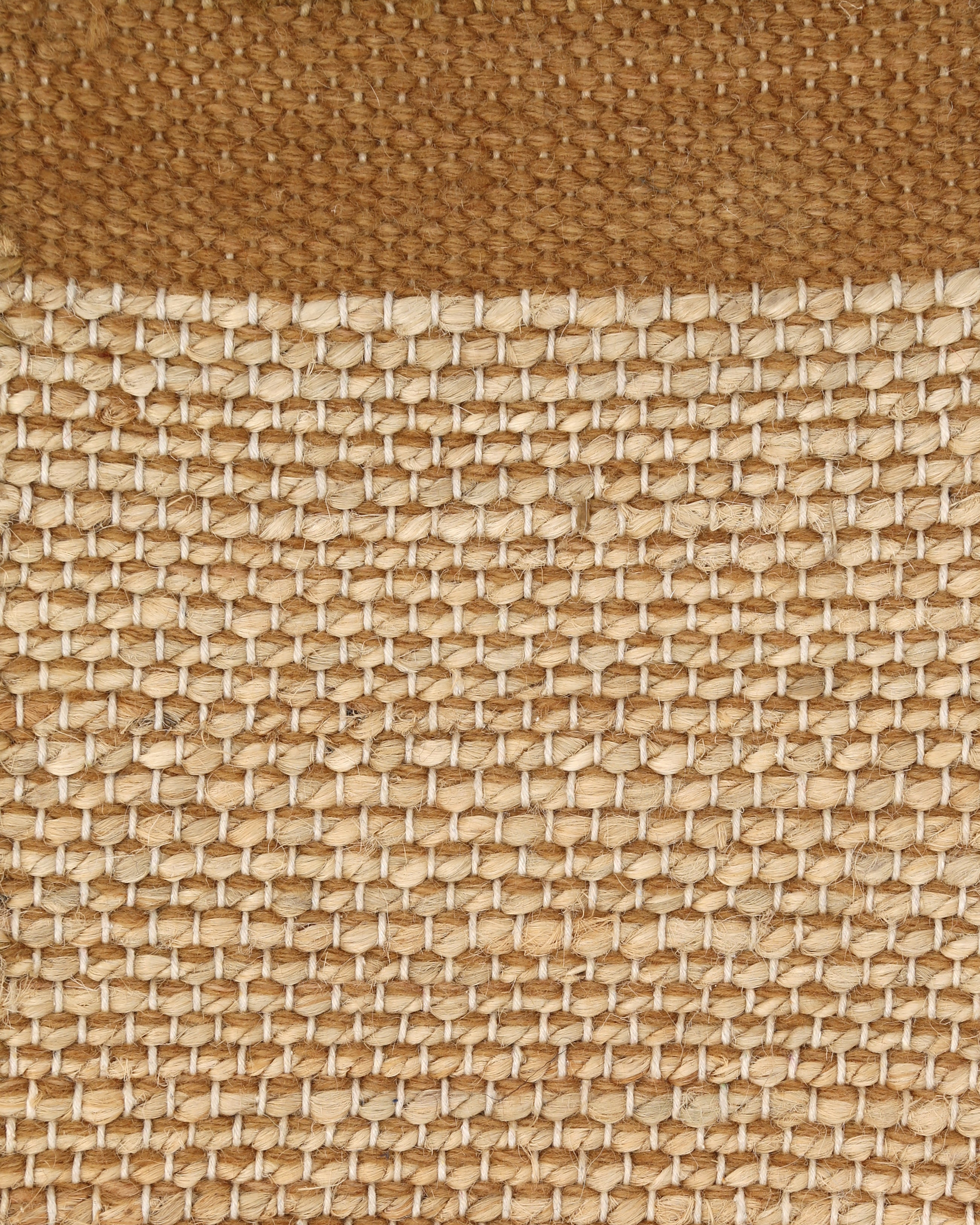 A rectangular jute rug with a textured design in beige and brown colors.
