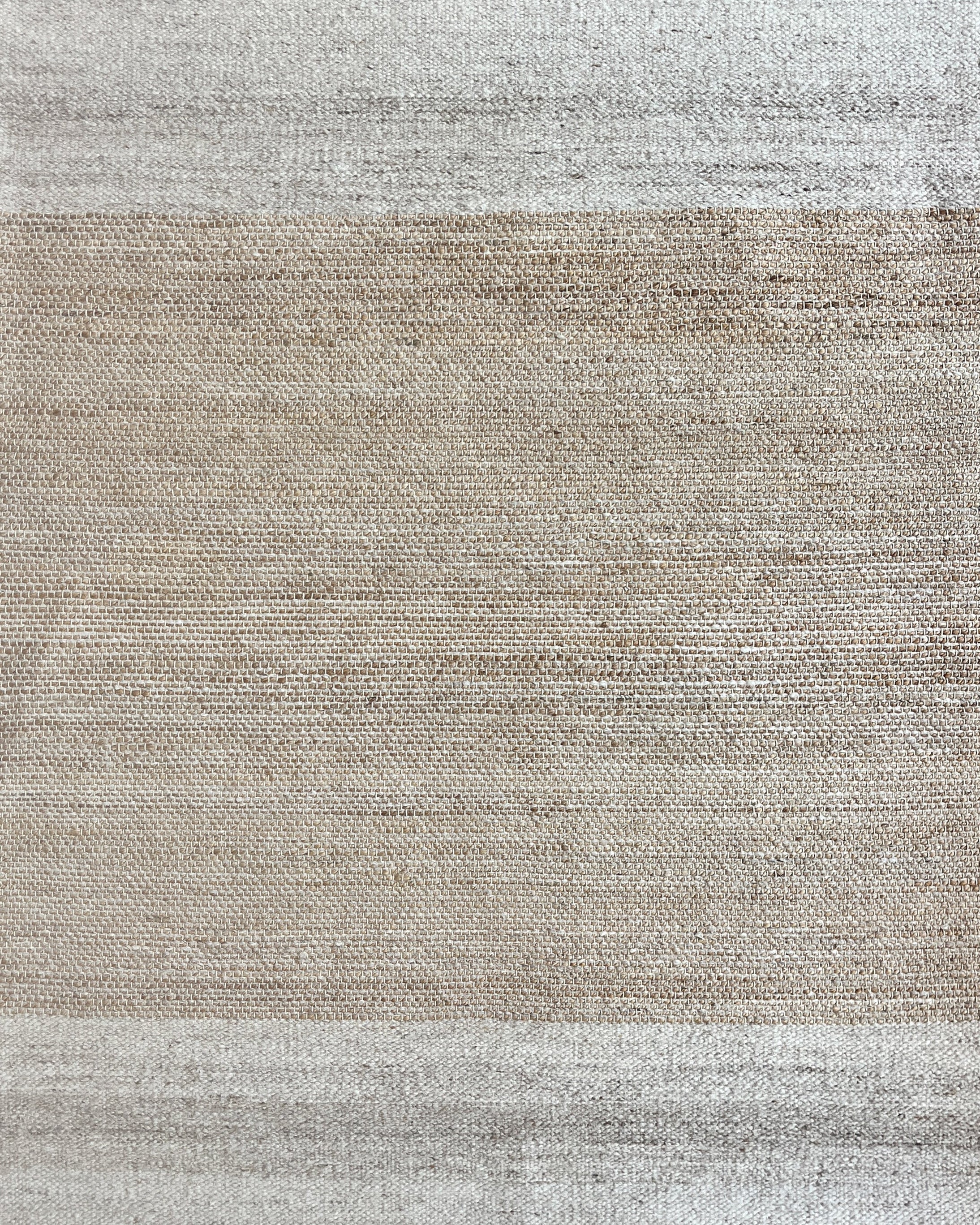 Gradient rug with beige and gray colors on a white background