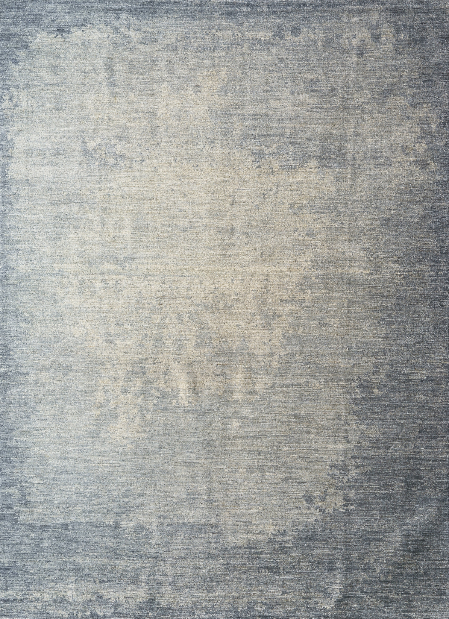 A rectangular rug with a petrol blue color that transitions into lighter shades towards the edges organic shade