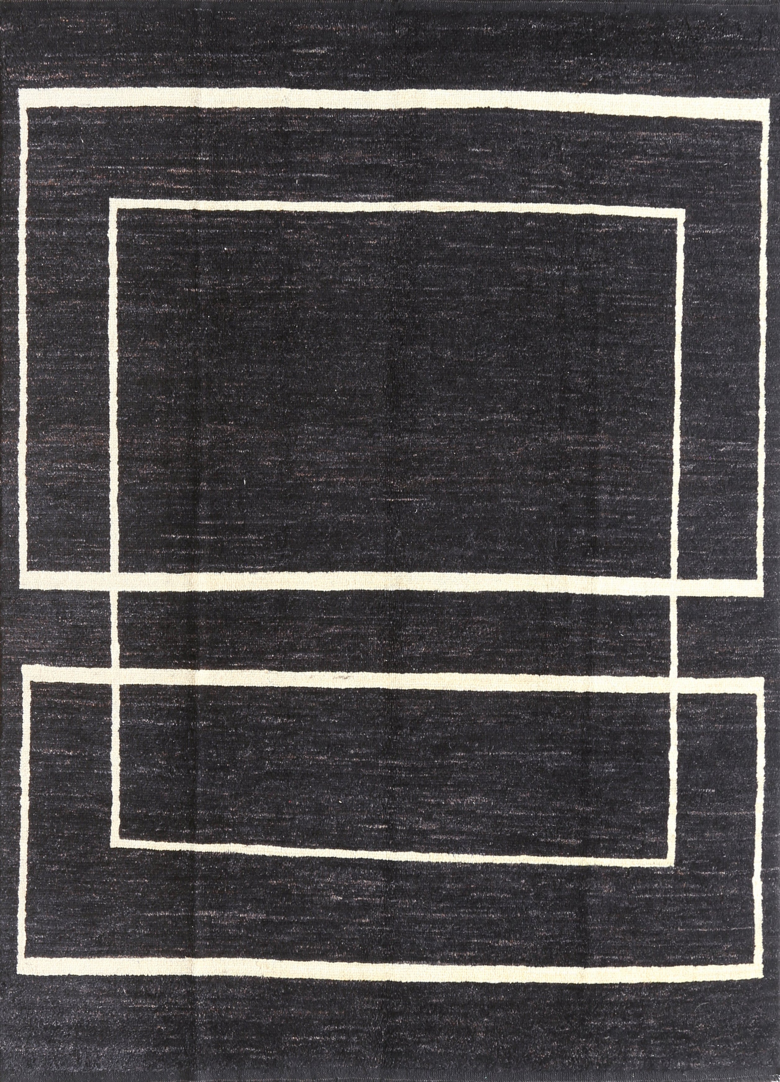 A black and beige geometric patterned area rug.
