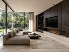 Modern living room with a large sofa, coffee table, and wall-mounted TV.