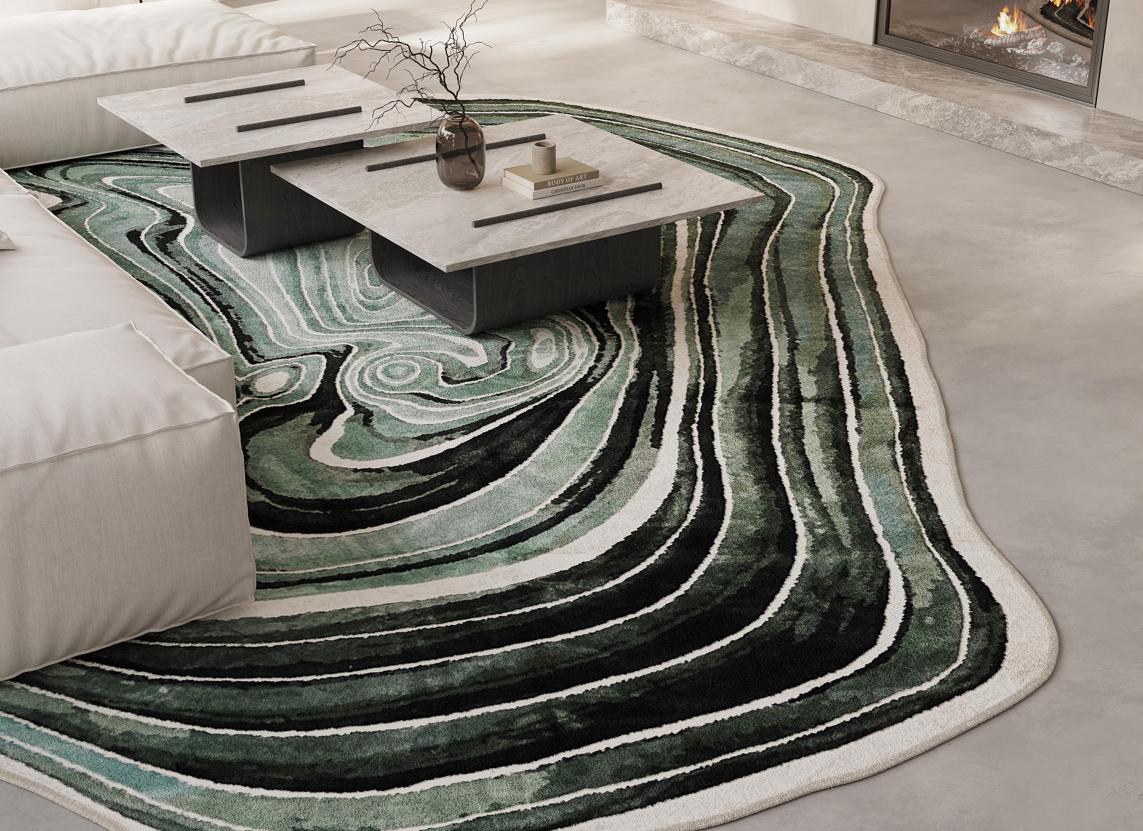 Modern living room with a green and white patterned organic rug, white sofa, and marble coffee table.
