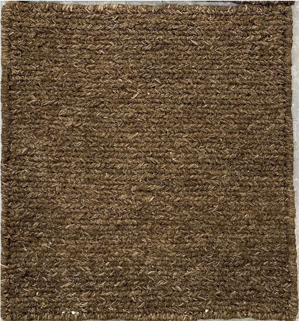Brown textured doormat on a gray background