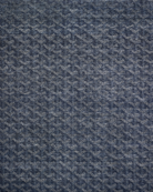 Textured blue rug with geometric pattern on a plain background