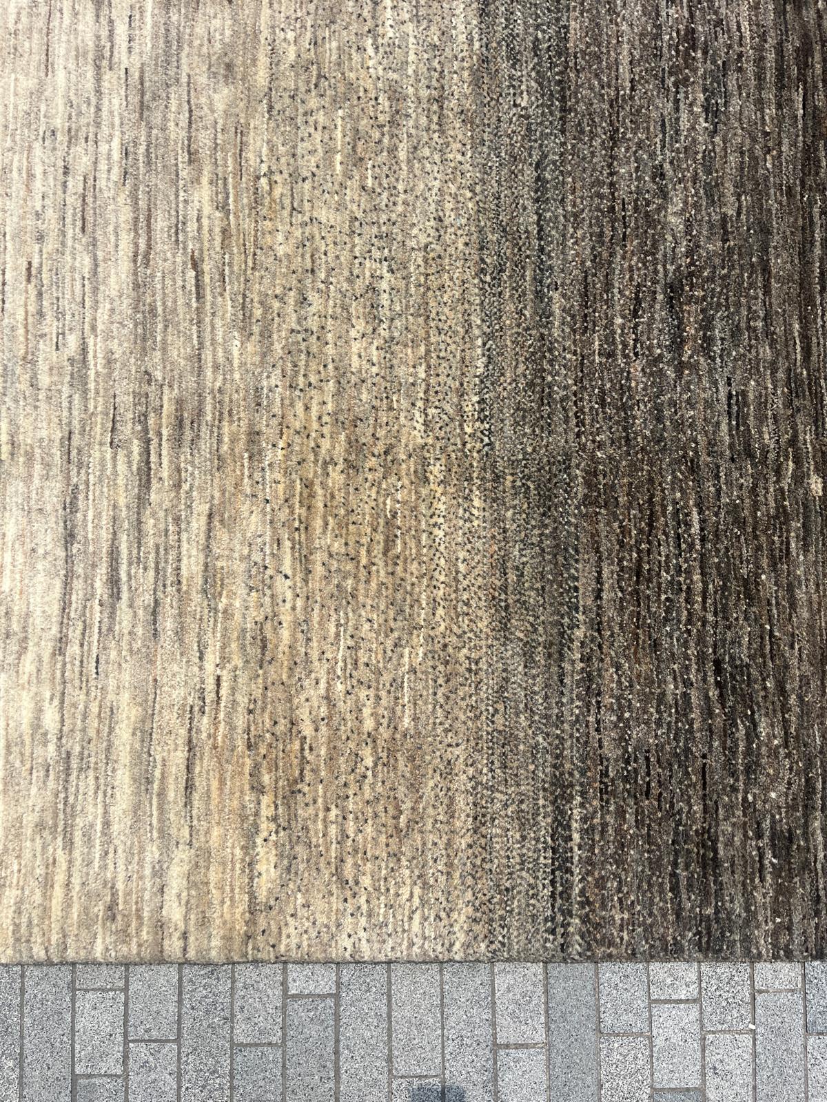detail of Persian Gradient of Iran rug in undyed wool, featuring a natural light-to-dark gradient pattern, handcrafted by Ashtari Carpets