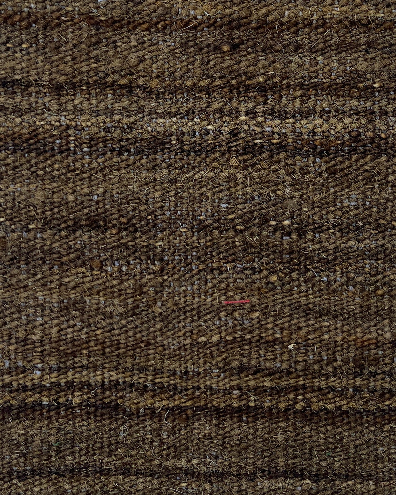 Close-up of brown textured fabric with subtle pattern